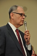 Wendell Potter speaking into a microphone